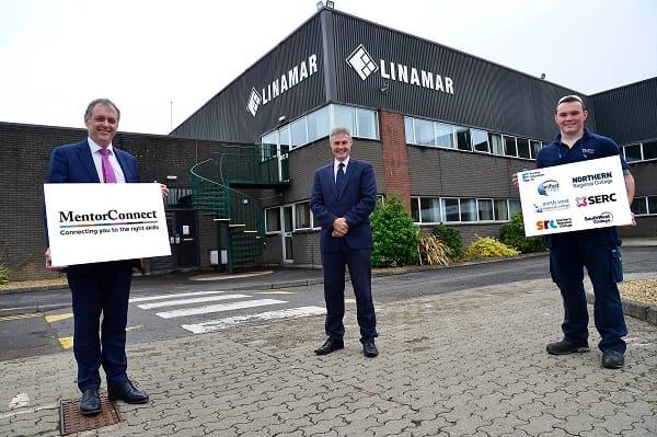 William Greer holding mentor connect sign, Minister Paul Frew MLA and Apprentice Jonny Bryans